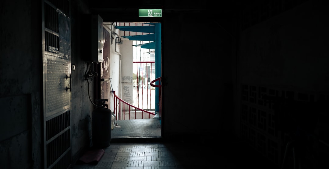 Glass-cased emergency access door — Bitwarden\'s Emergency Access feature gives a trusted contact recovery rights to your vault