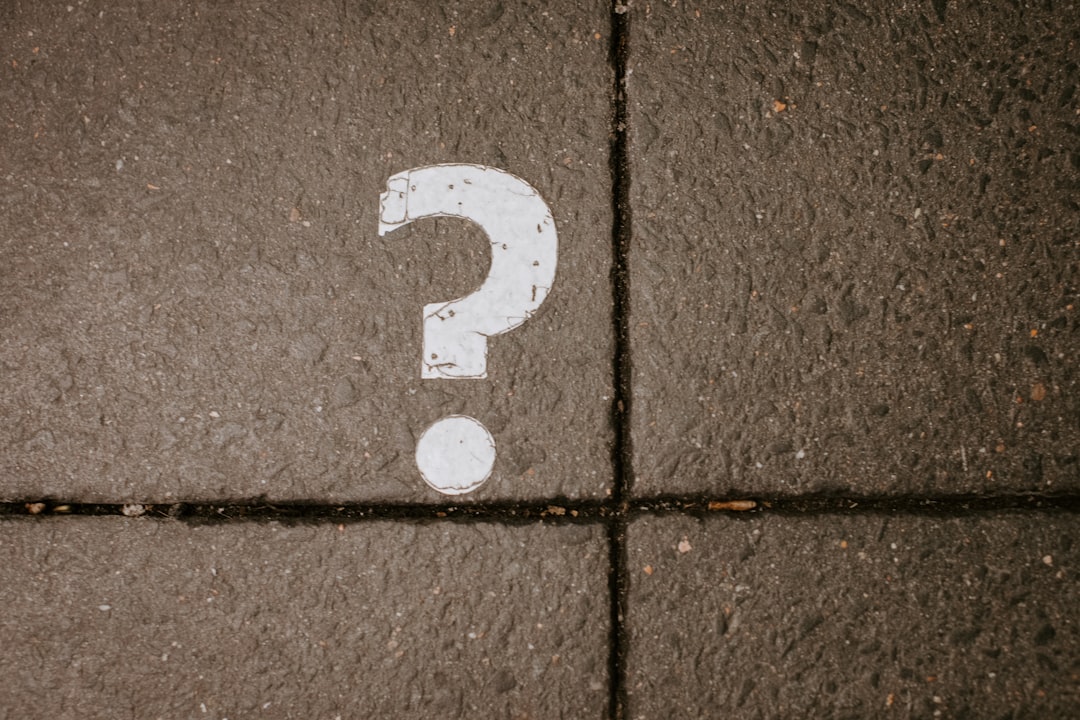 Question marks scattered on a chalkboard — answers to the most common Bitwarden questions covering install, security, pricing and migration